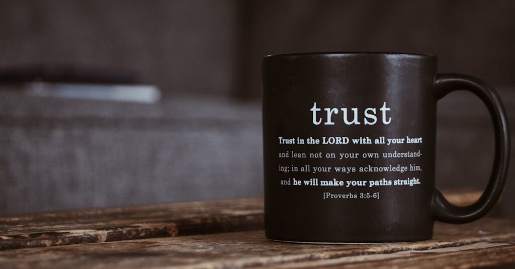 Prayer Ministries | English A rustic black mug with an inspirational religious quote from the Bible on a wooden table.